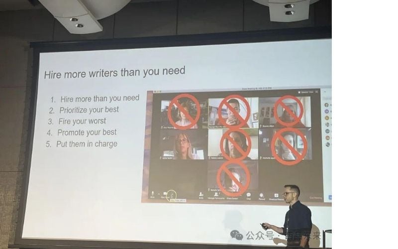 一位演讲者站在投影屏幕前，屏幕上展示着标题为“Hire more writers than you need”的幻灯片，其中包括五点建议和一张视频通话的截图，截图中的部分头像被红色禁止标志覆盖。